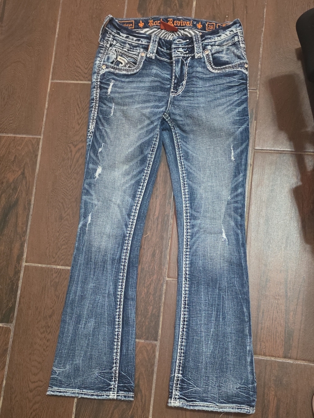 Rock Revival Women's Faded Blue Flare Jeans with Distressed Detailing